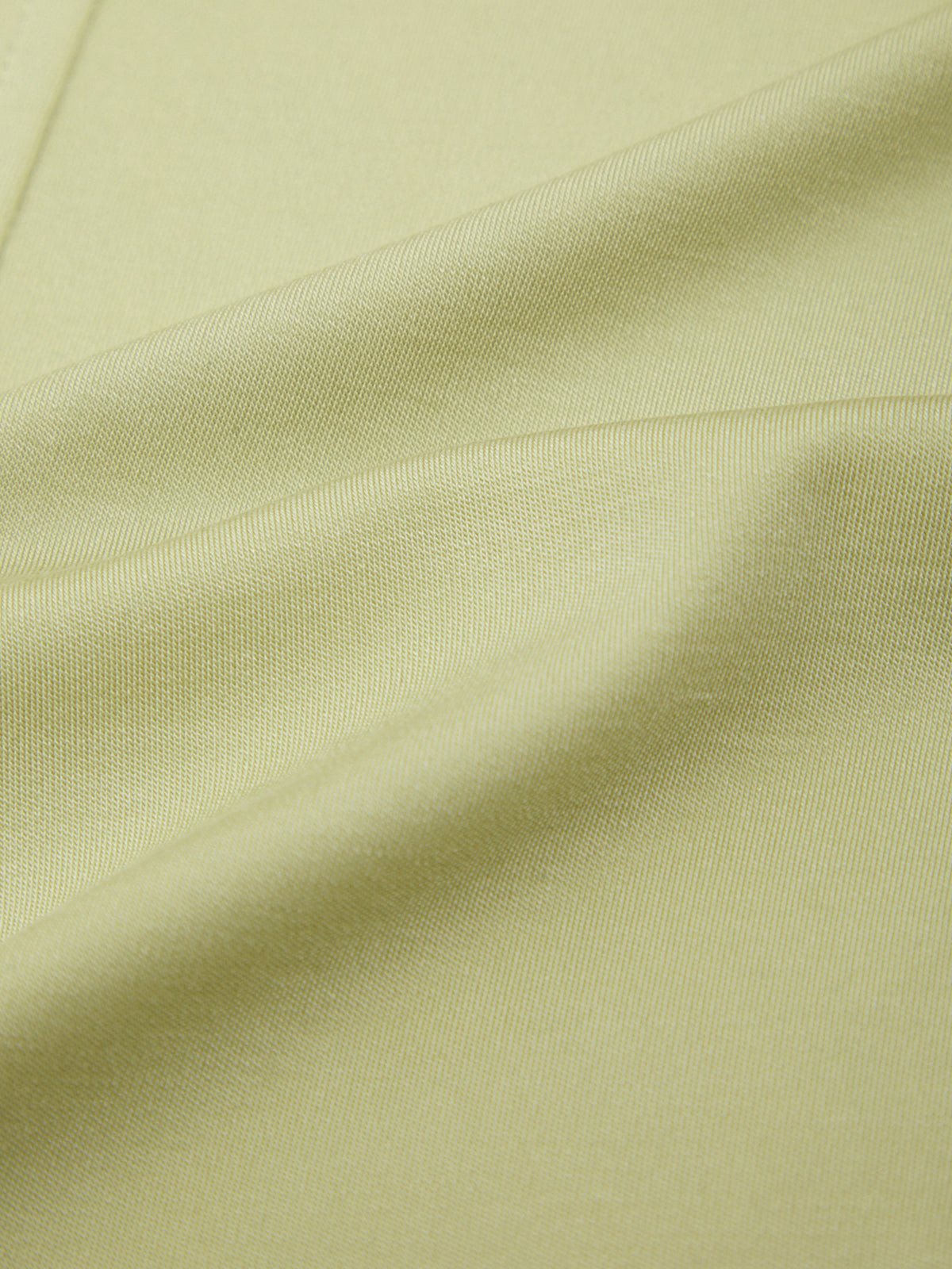 Close-up of light green fabric with visible texture