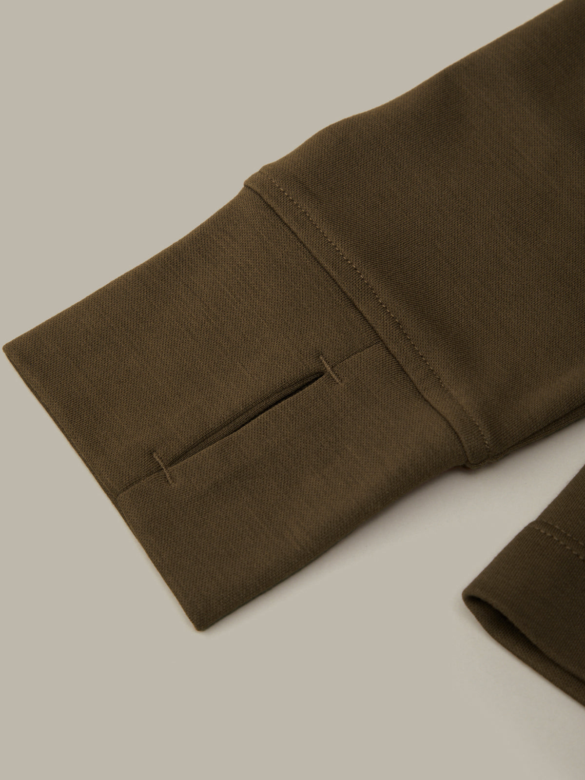 Brown pants with a pocket on a beige background