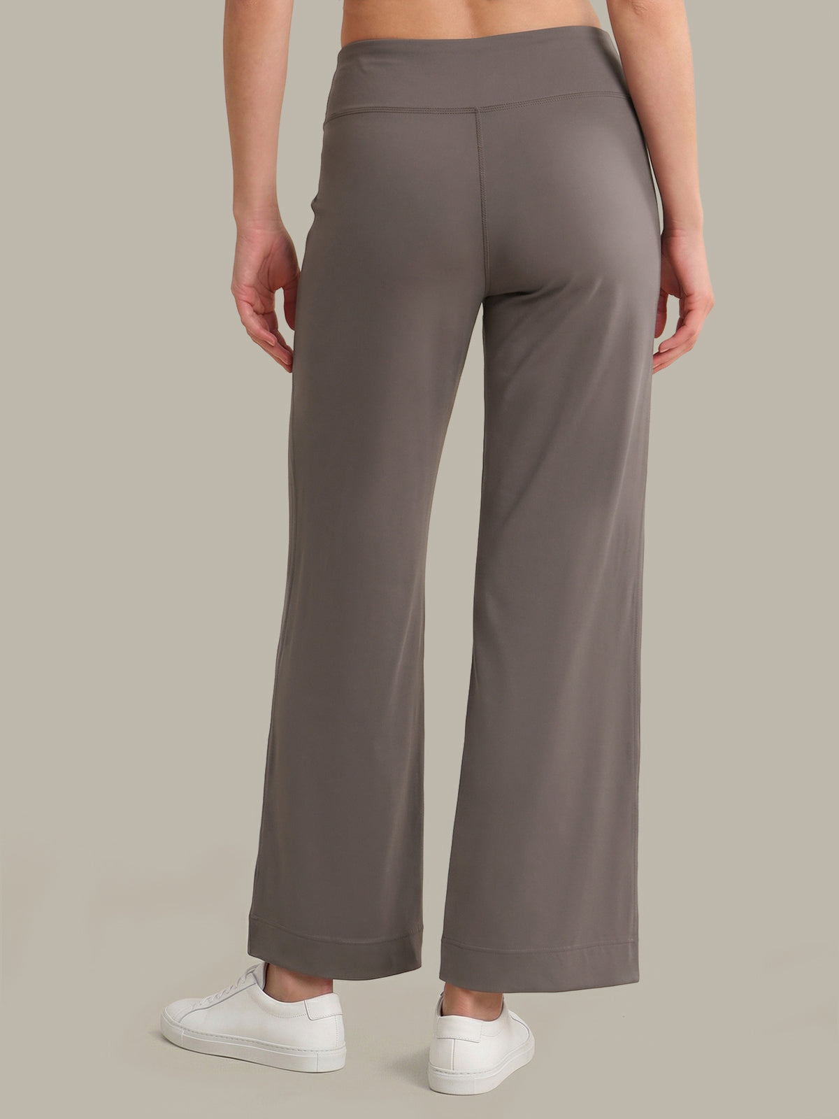 Person wearing Grey wide-leg pants on a plain background