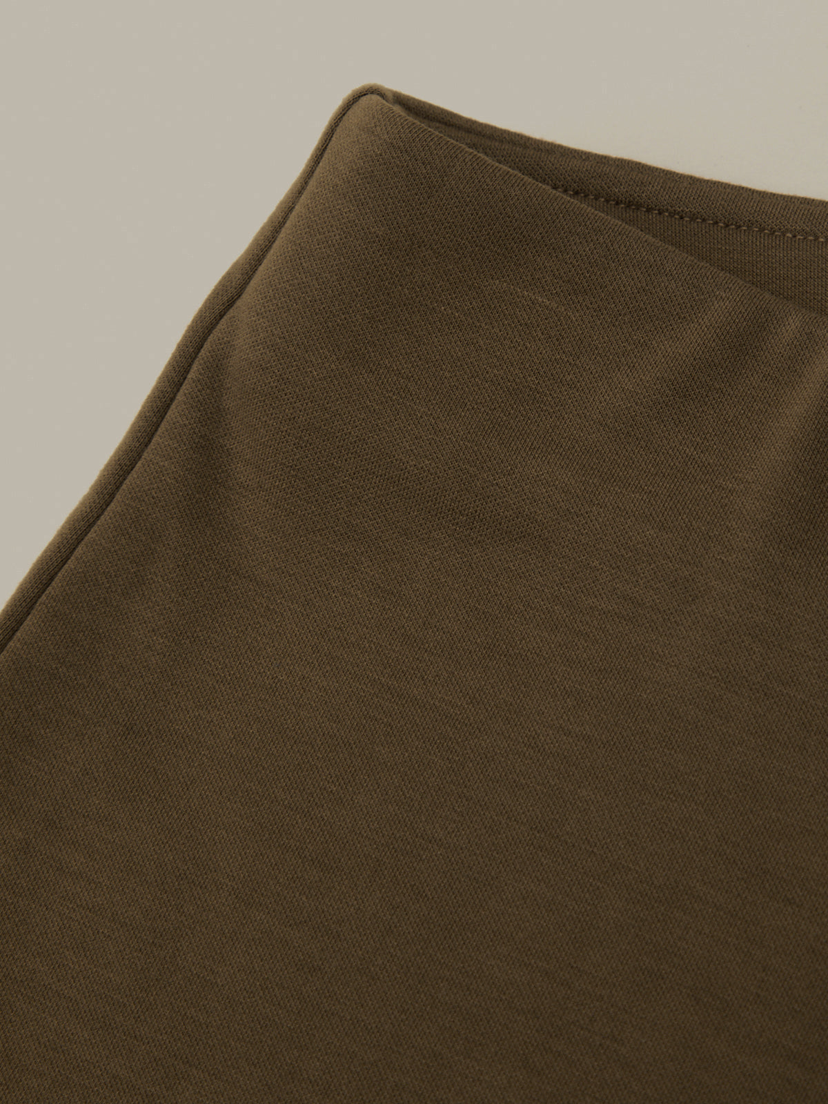 Close-up of a brown fabric texture on a plain background