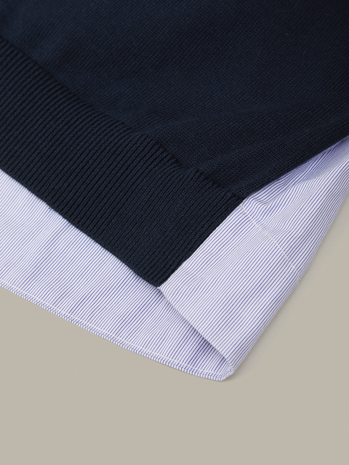 Close-up of a black and white striped fabric edge on a beige background