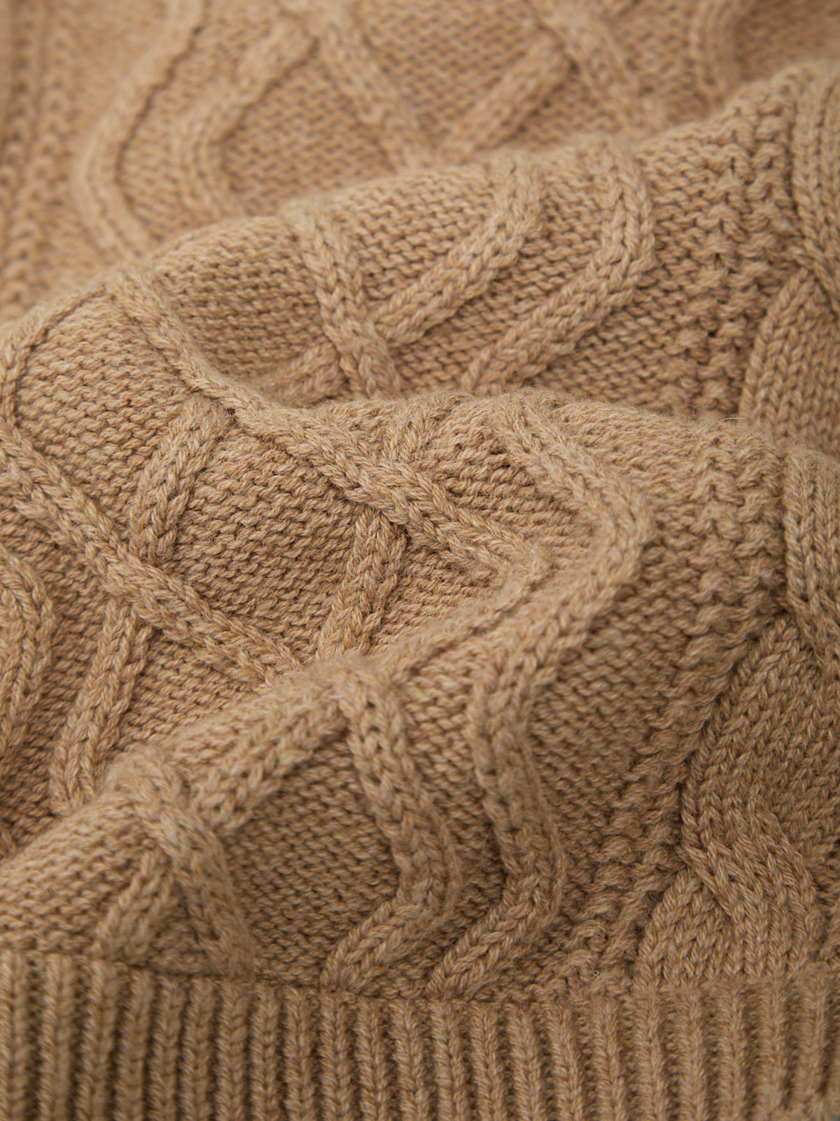 Close-up of a brown knitted fabric with cable pattern