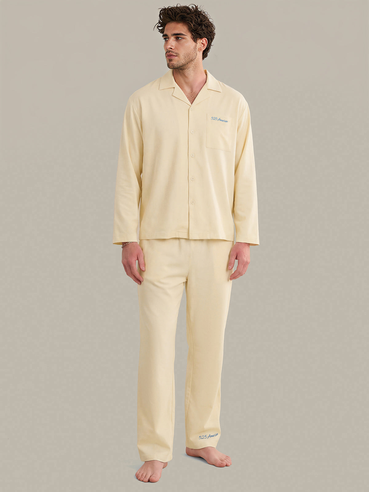 Man wearing a light yellow pajama set against a plain background