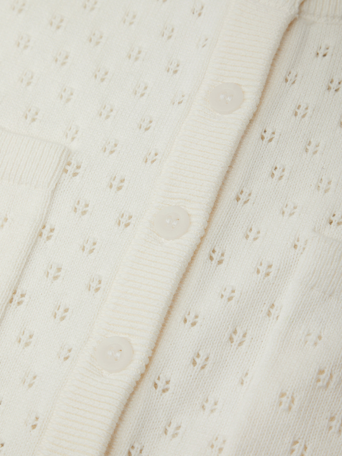 Close-up of a textured white fabric with subtle patterns