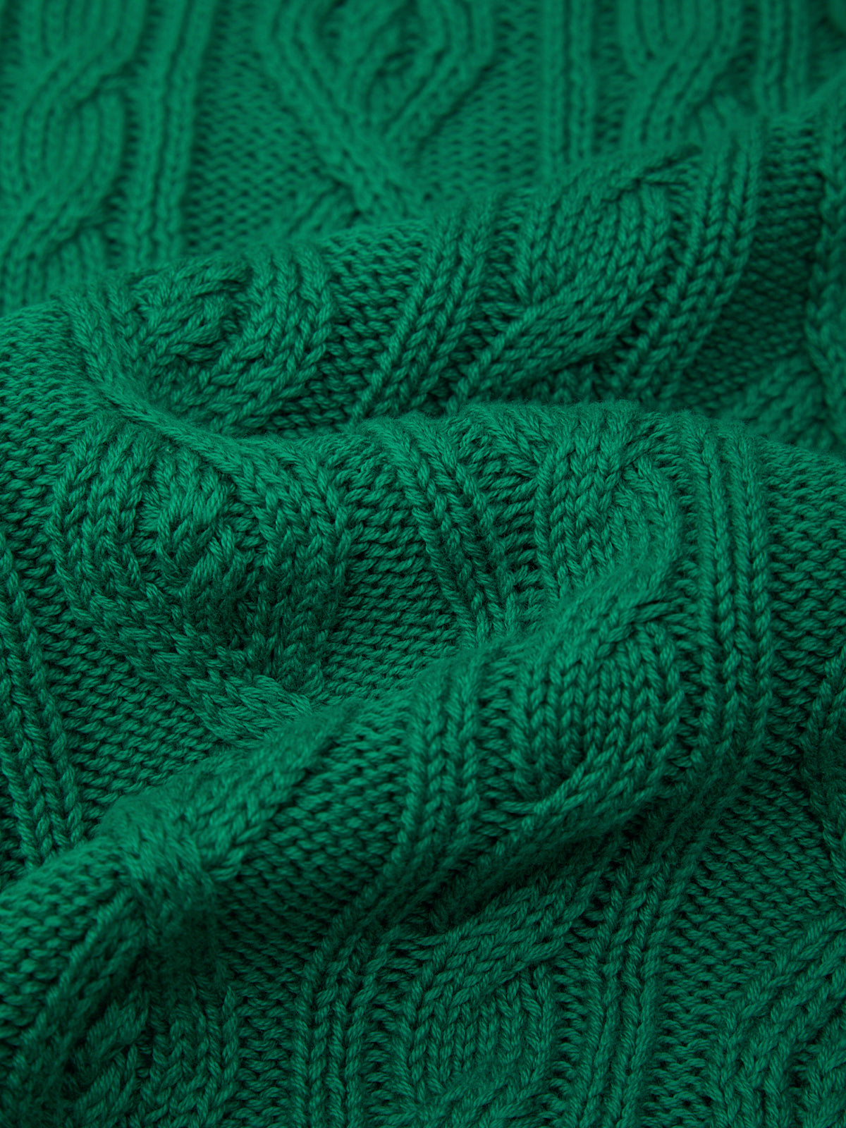 Close-up of a textured green fabric with intricate patterns