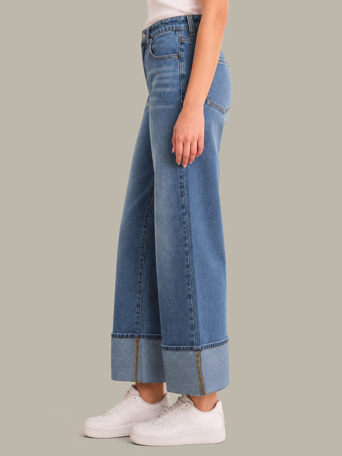 Wide-leg jeans worn by a person on a gray background
