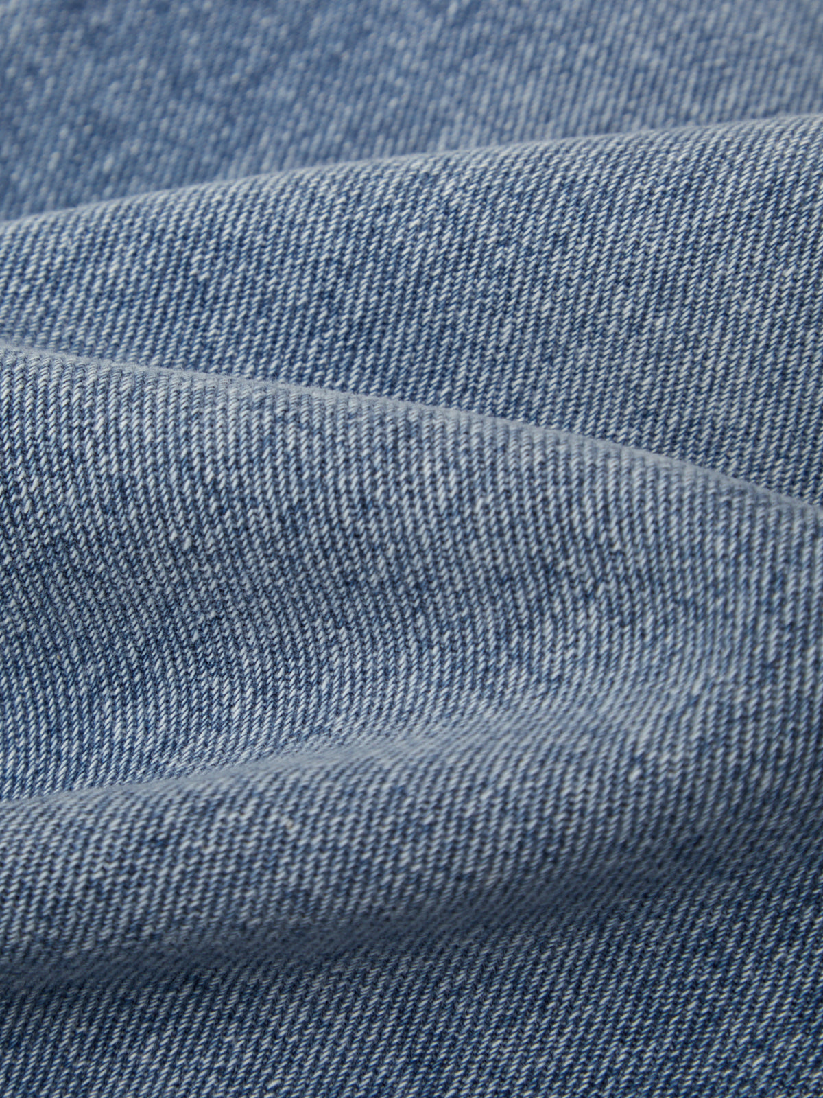 Close-up of blue denim fabric with visible texture