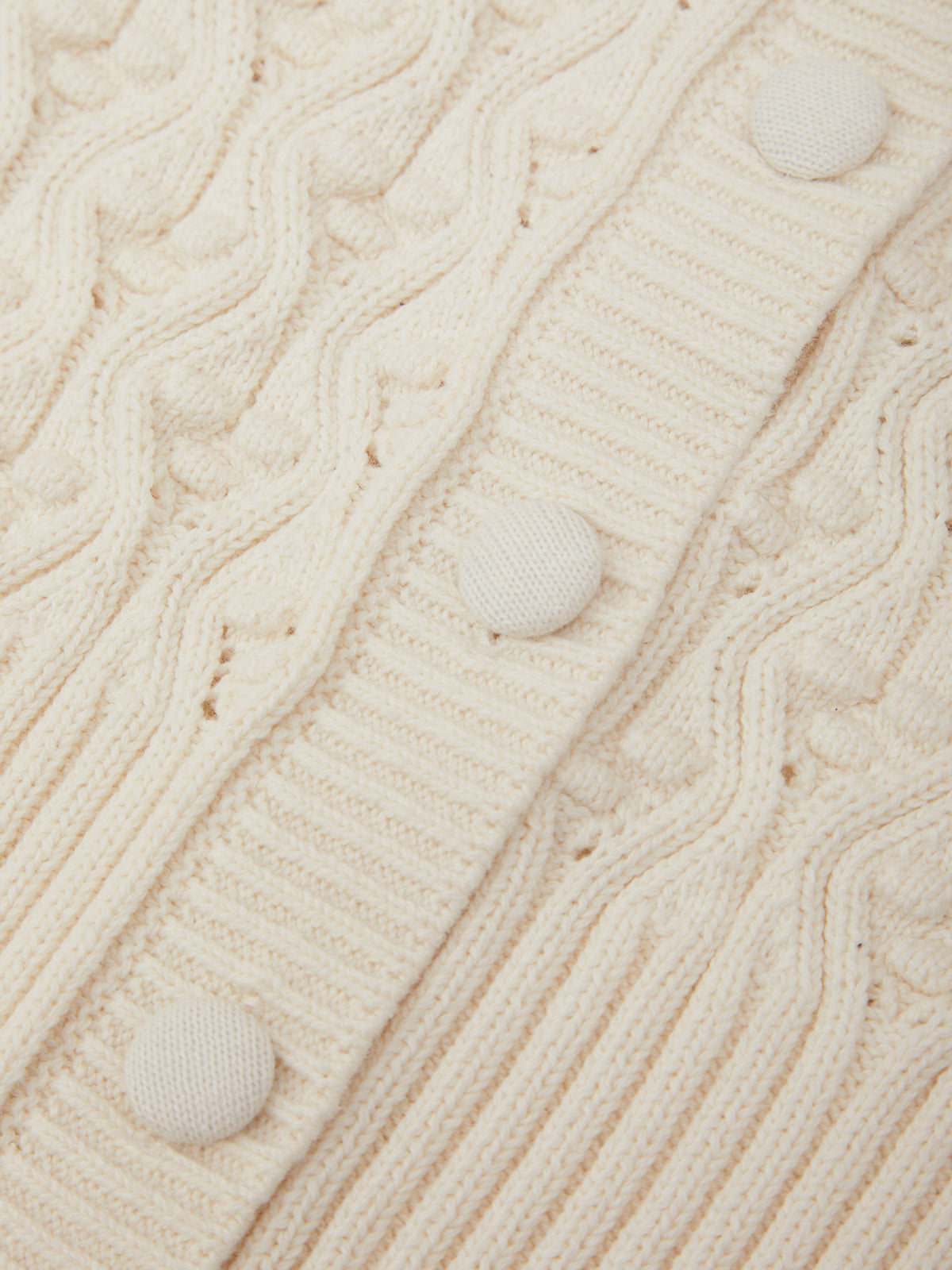 Close-up of a textured beige fabric with button details