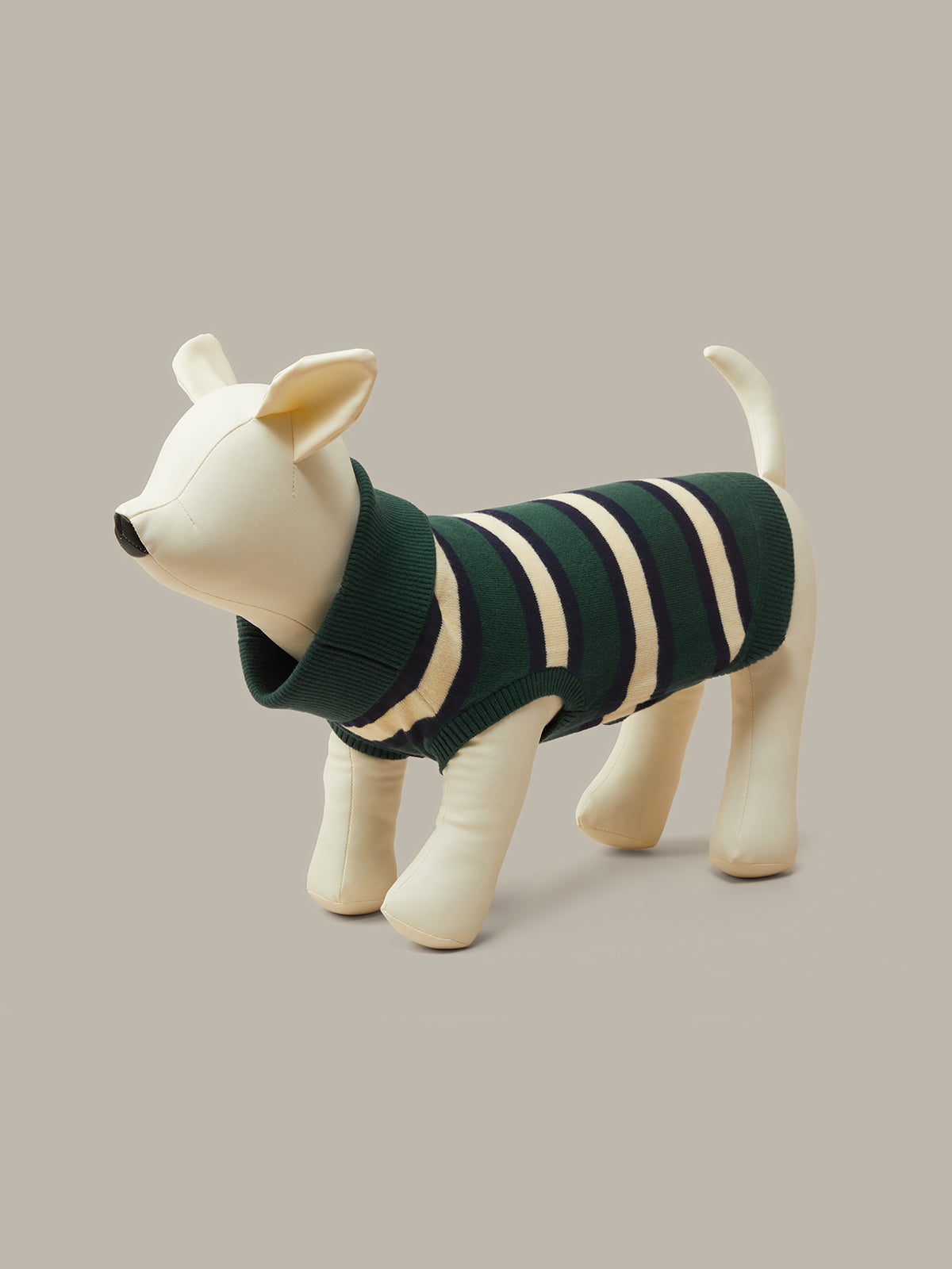 A cream-colored dog-shaped mannequin wearing a dark green and cream striped knit sweater, set against a solid light gray background.