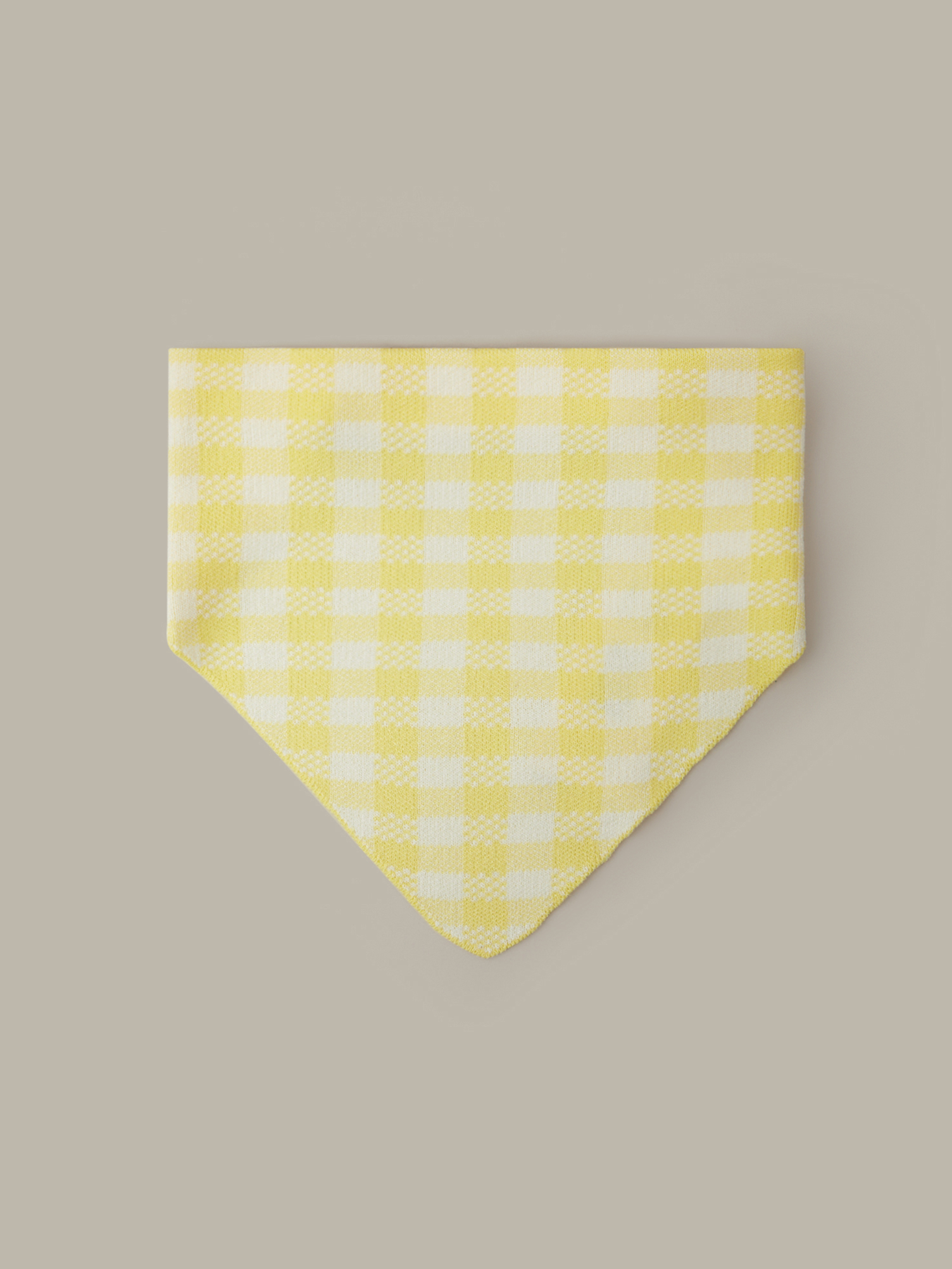 Yellow and white checkered bandana on a beige background