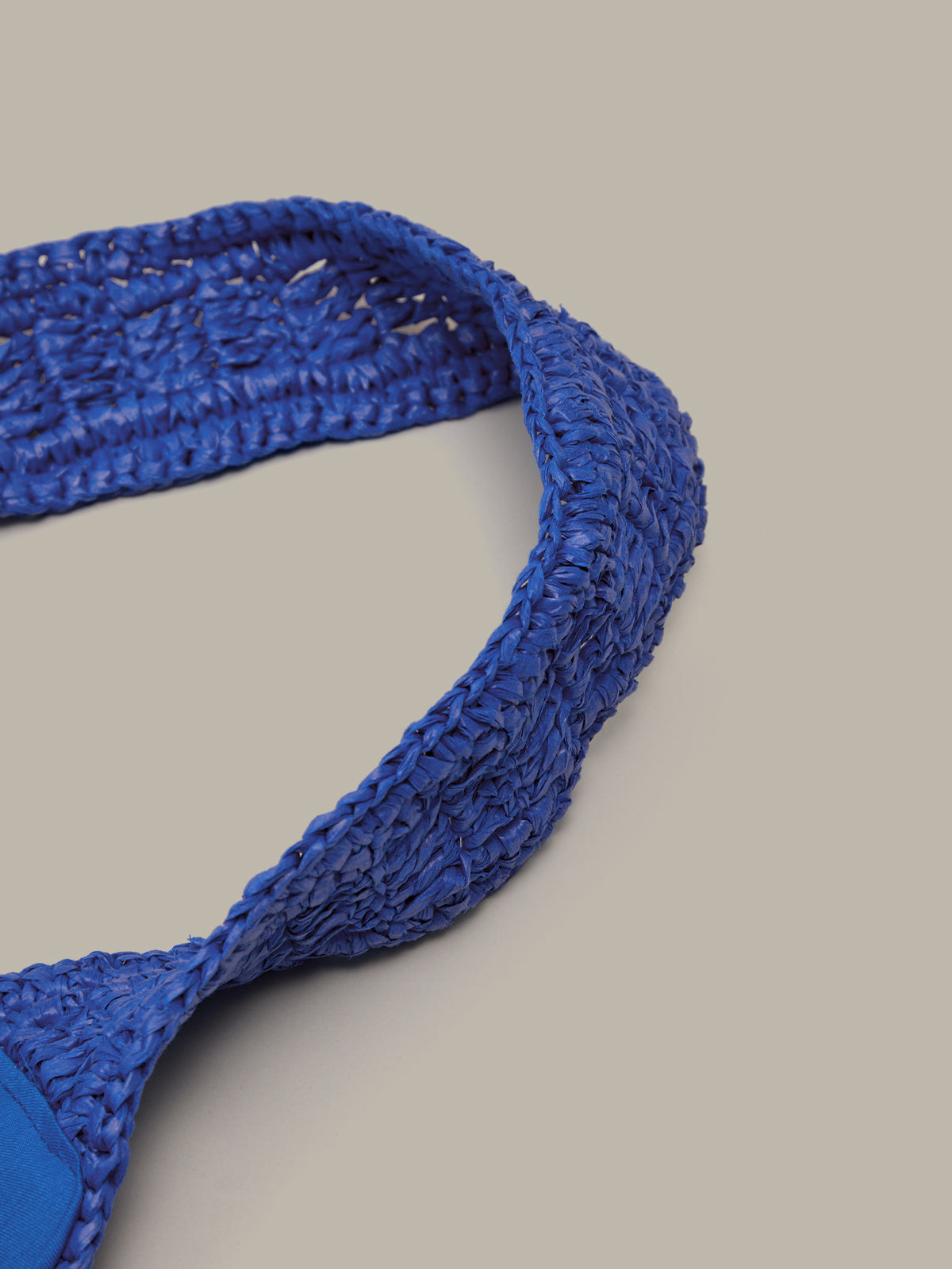 Blue woven belt on a light gray background