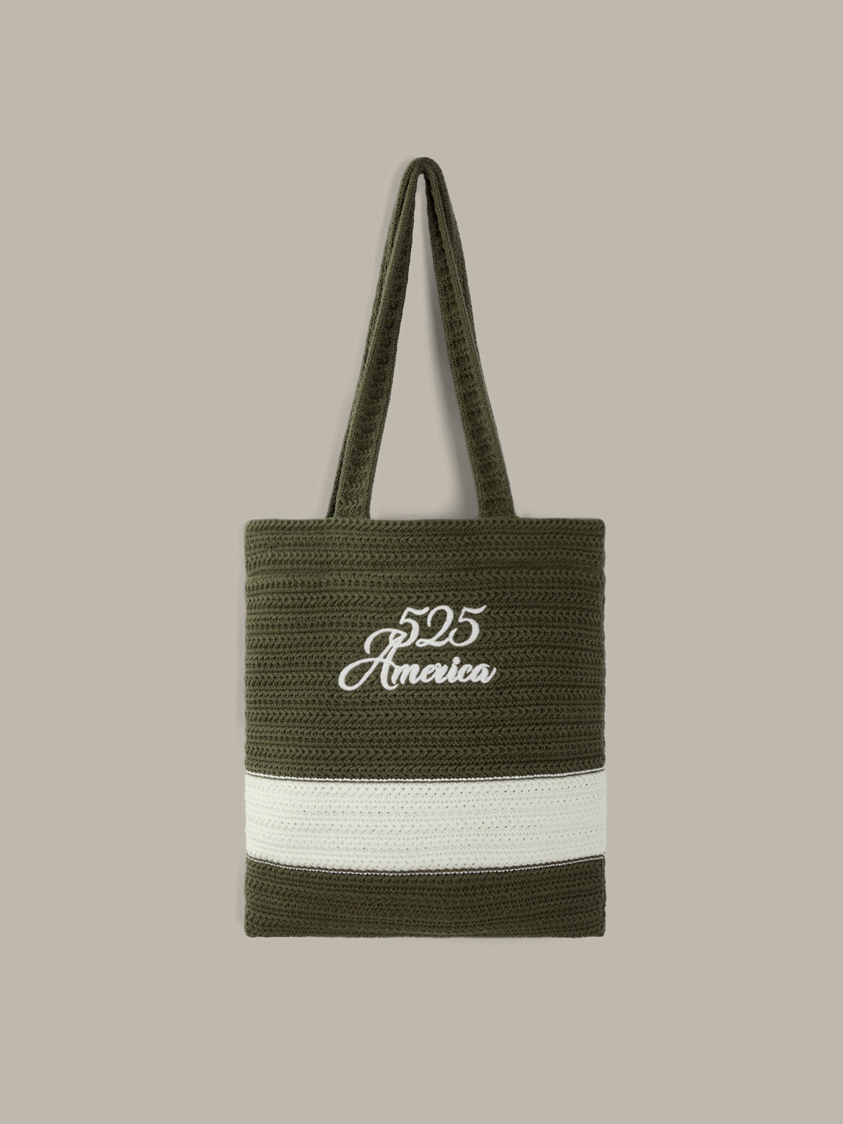 An olive green woven tote bag with a white horizontal stripe and white embroidered '525 America' logo, shown against a solid taupe background.