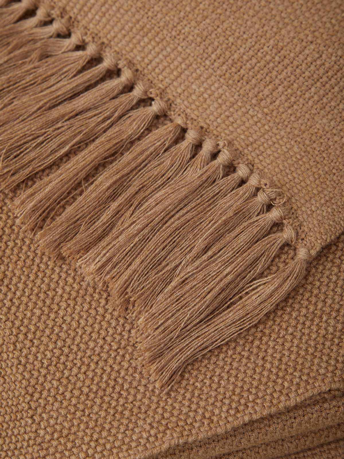 Close-up of a brown fabric with fringed edge