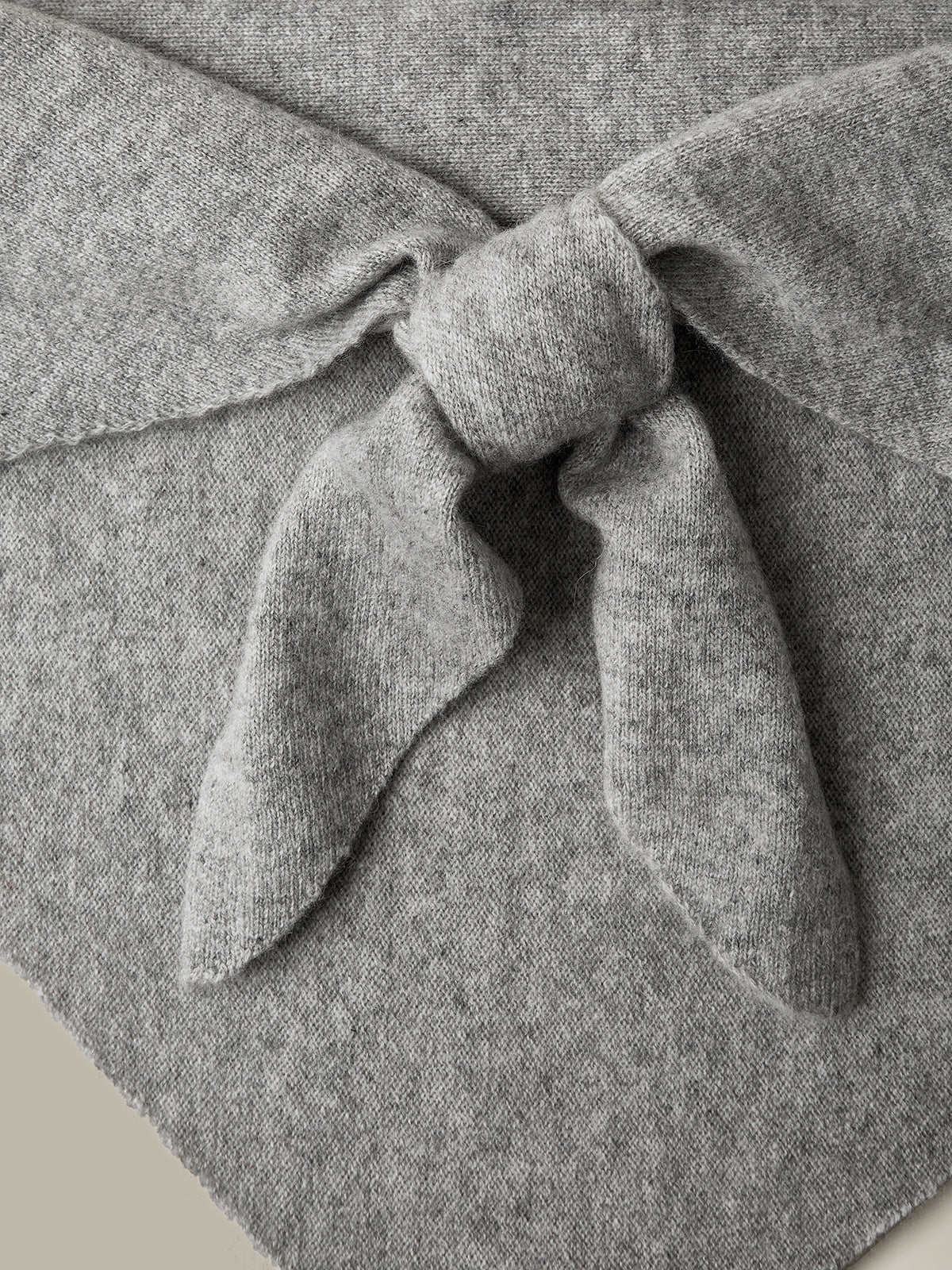 Gray fabric with a knot detail on a neutral background