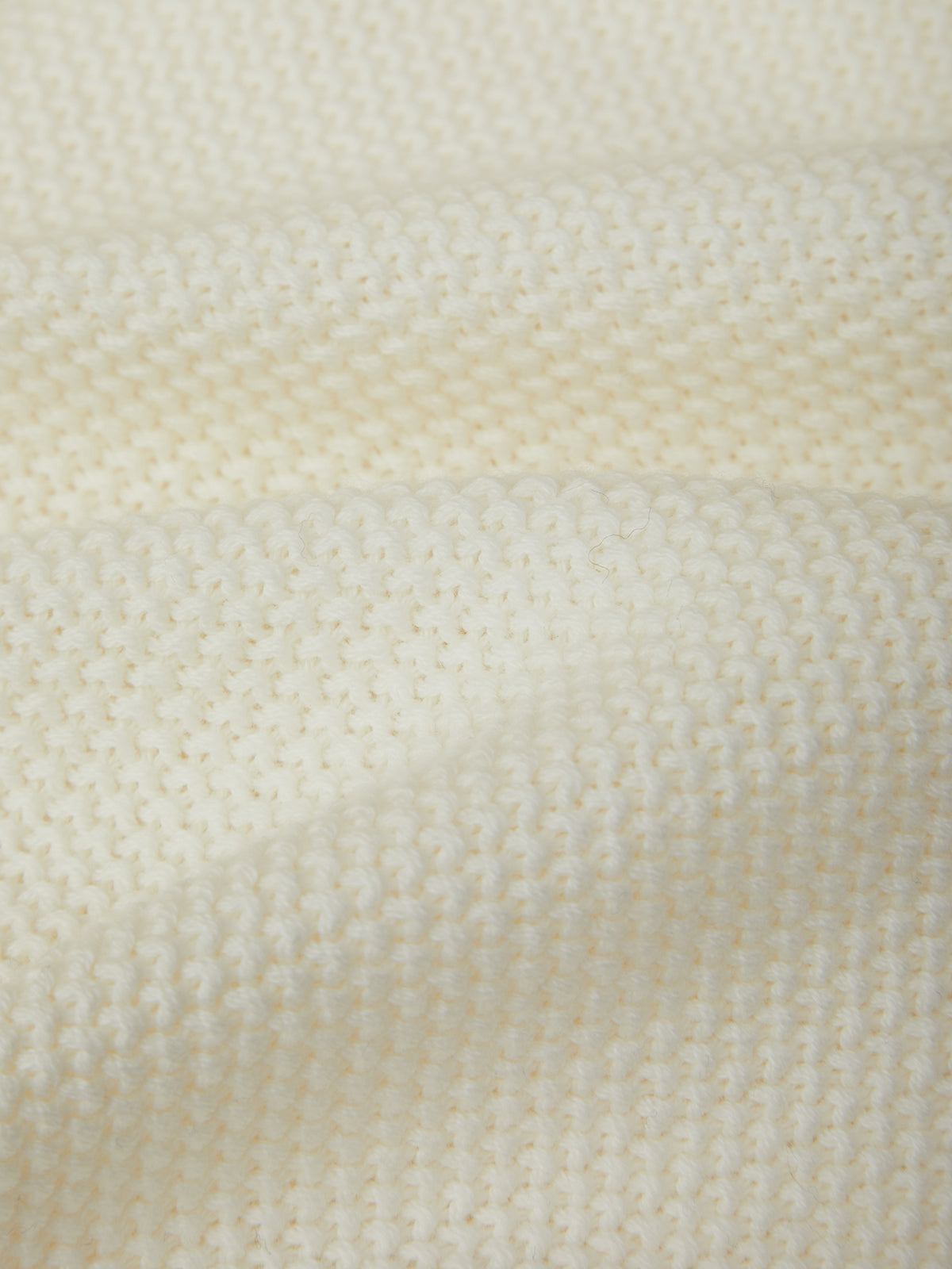Close-up of a textured beige fabric surface