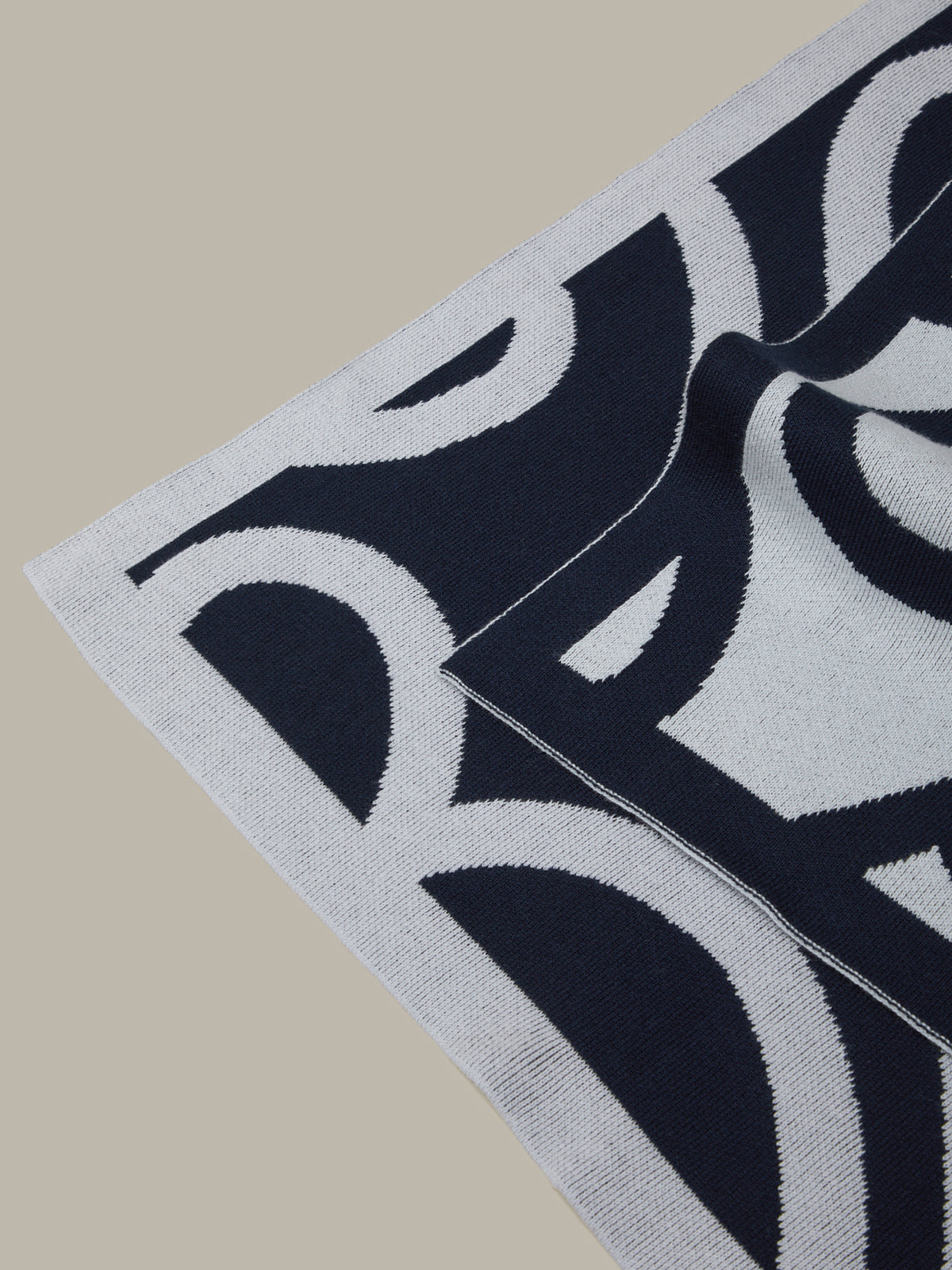 Close-up of a black and white patterned rug on a beige surface
