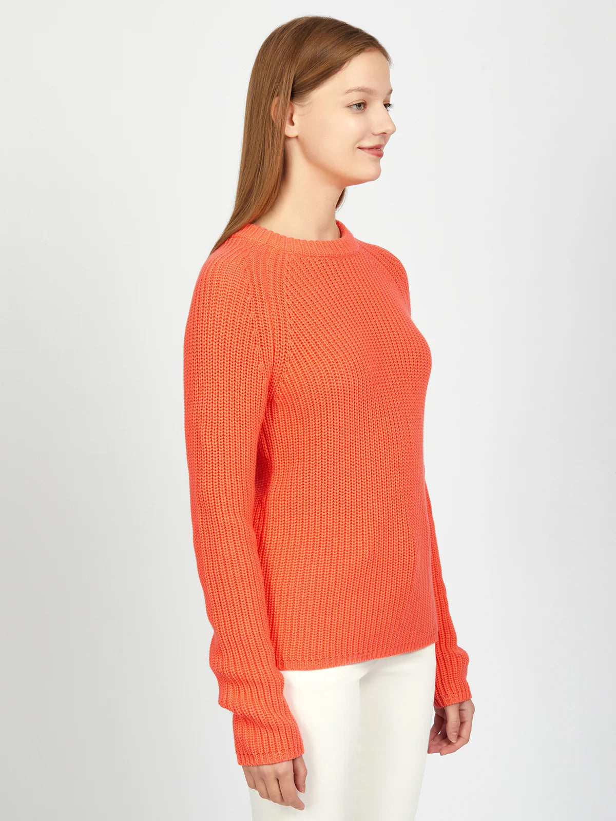 Person wearing an orange sweater on a white background