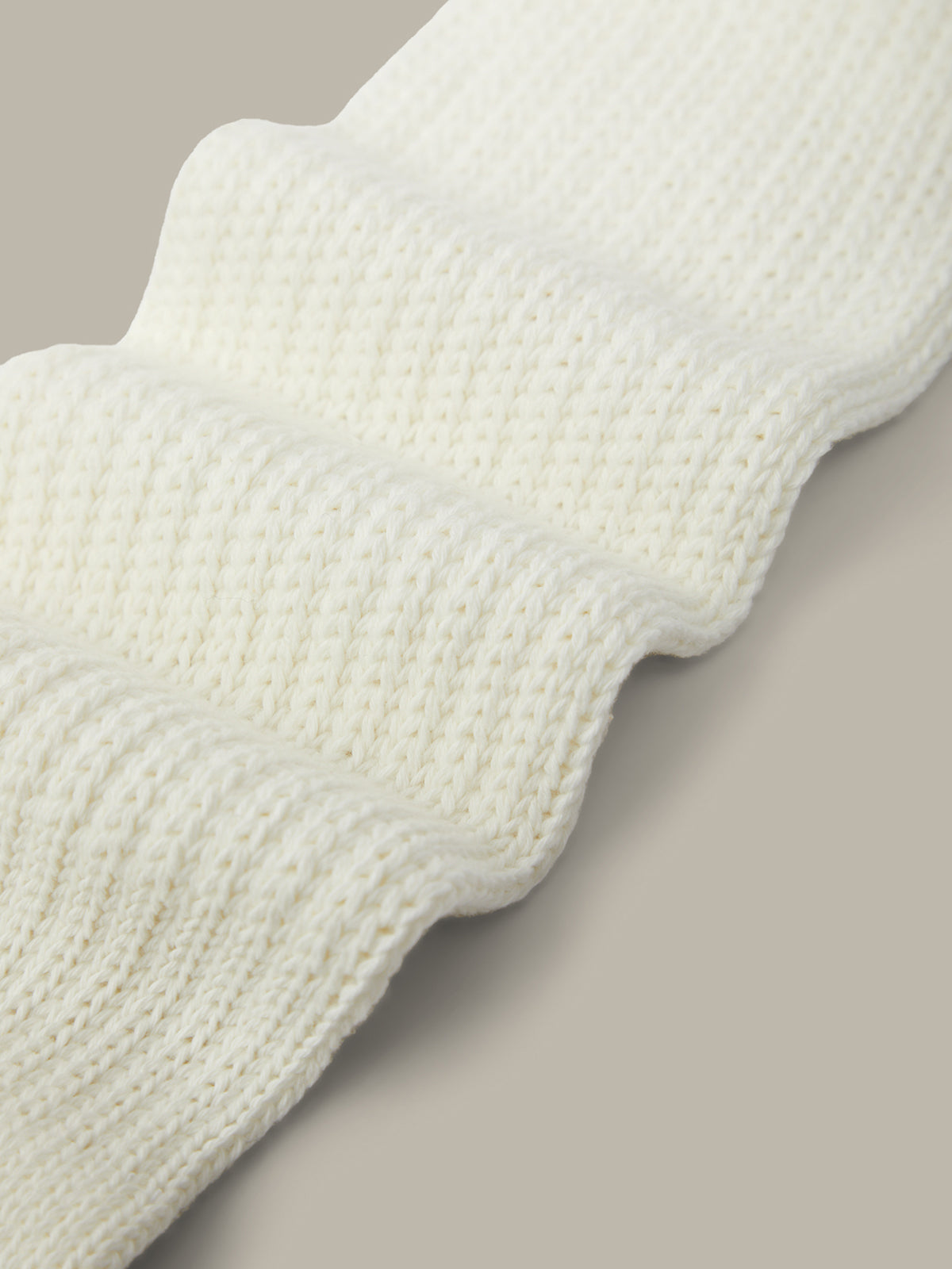 Close-up of a textured white fabric on a beige background